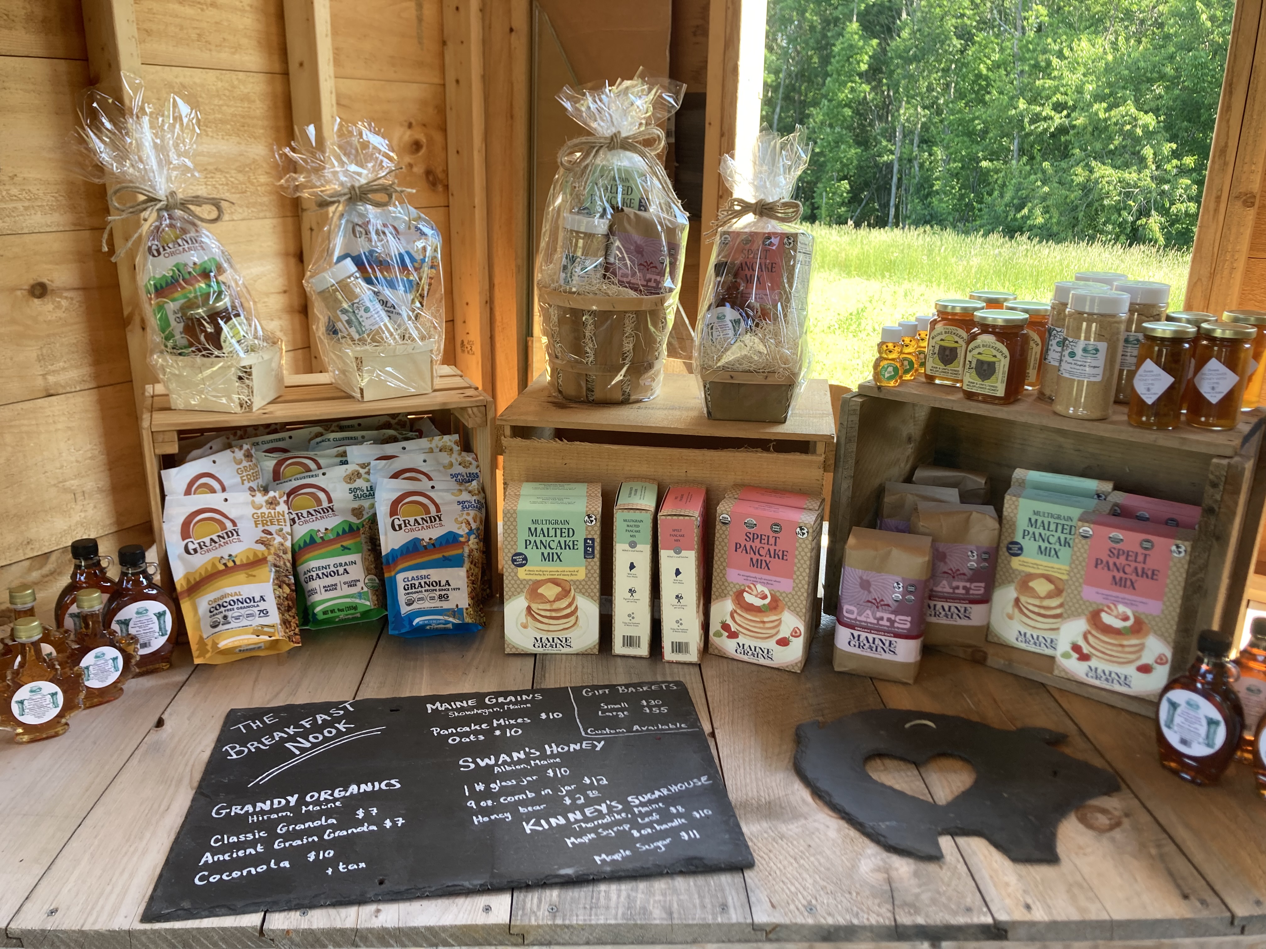 The breakfast nook at Orchard View Farm Market featuring Maine Grains spelt and malted barley pancake mixes as well as oats, Grandy Organics granola and coconola, Kinney's Sugarhouse maple syrup and maple sugar, Swan's Honey honey products and gift baskets featuring these local Maine-made products.