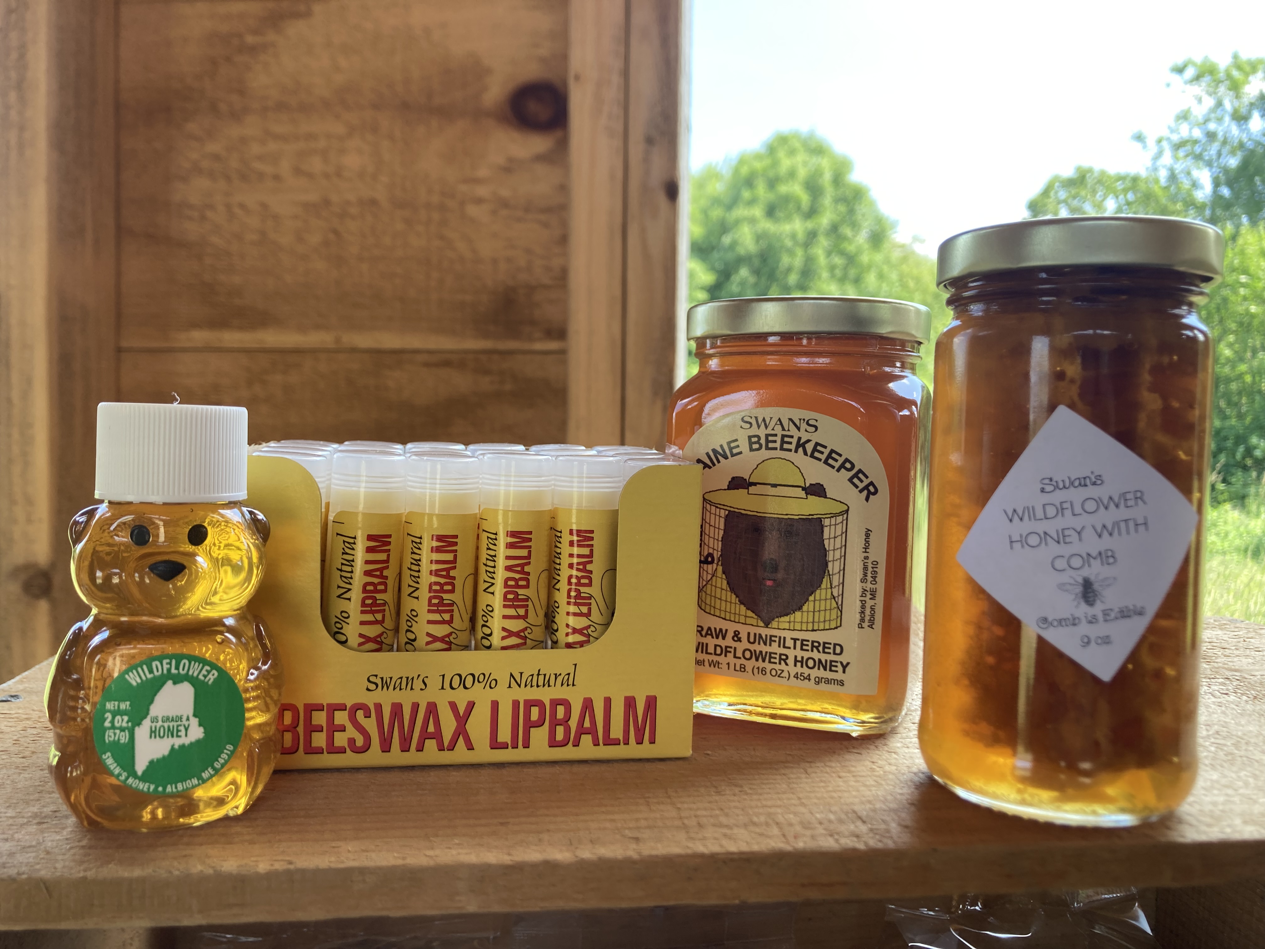 Raw and unfiltered wildflower honey, wildflower honey with honeycomb, honey bears and 100% natural lip balm all locally sourced from Albion, Maine.